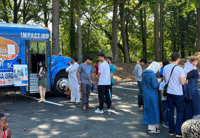 Families lined up outside of the mobile IMPACT Hub.