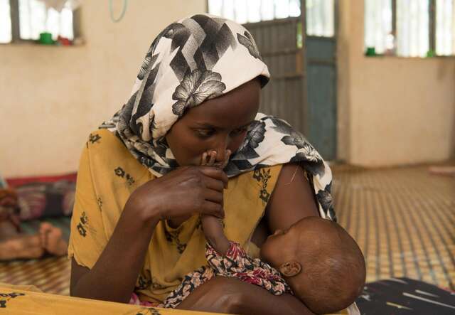 Hawo, 20, dotes on her six-month-old son, Hussein Ali. Ali was diagnosed with severe acute malnutrition and has been receiving treatment at the Eelkare health center.