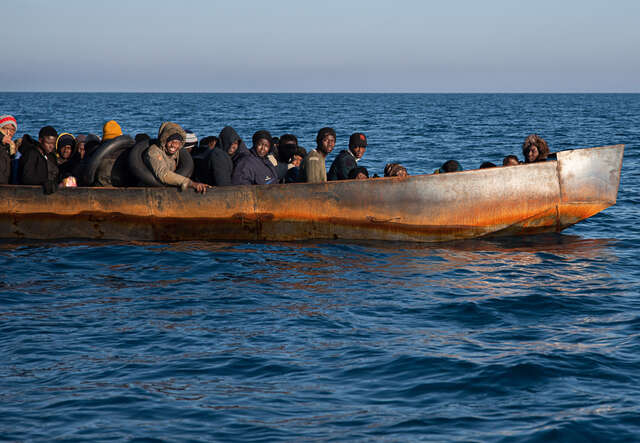 Migranter från södra Afrika i en båt utanför Italien.