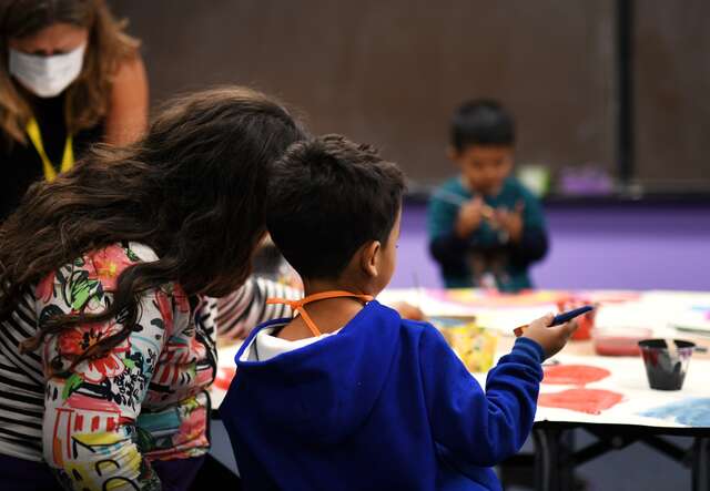 A mother and a son complete an activity together at the IRC welcome center in Phoenix, Arizona.