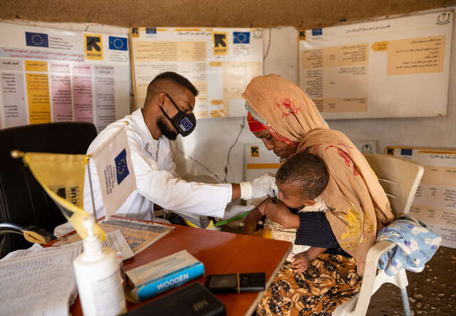 Dr. Mogahed screens a child for acute malnutrition at an IRC medical clinic in Gedaref, Sudan.