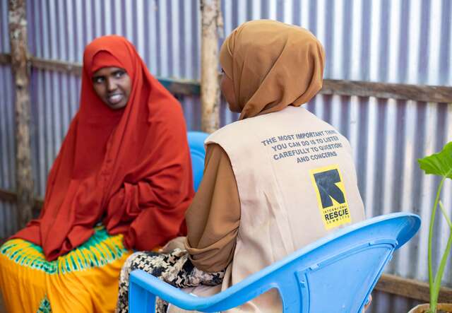 An IRC staff member speaks with a woman in Kenya.