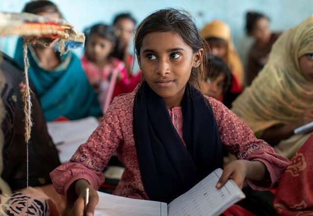 A female student attends class in Pakistan.