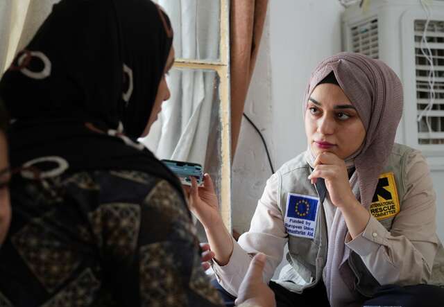 An IRC staff member consults a woman in Iraq.