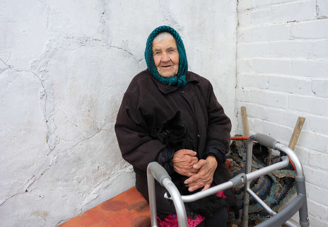 Marusia smiles for the camera, holding her pet cat.