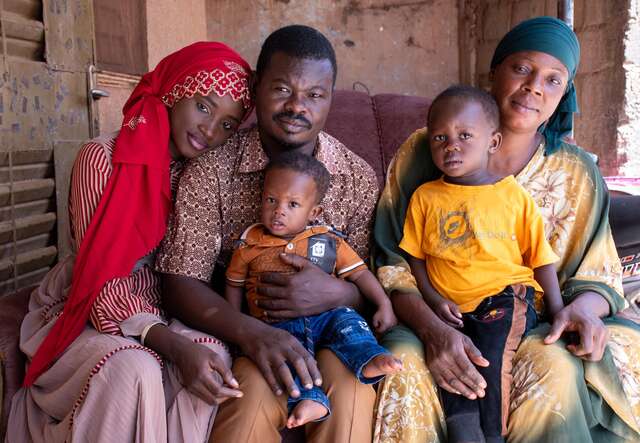 In Burkina Faso, Yann and Yannick pose for a picture with their parents, Aida and Gilbert, and grandmother.