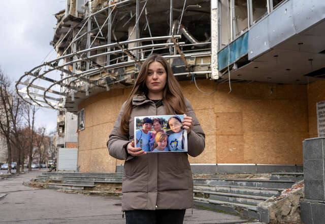 Marhartya holds a photo of her family together.