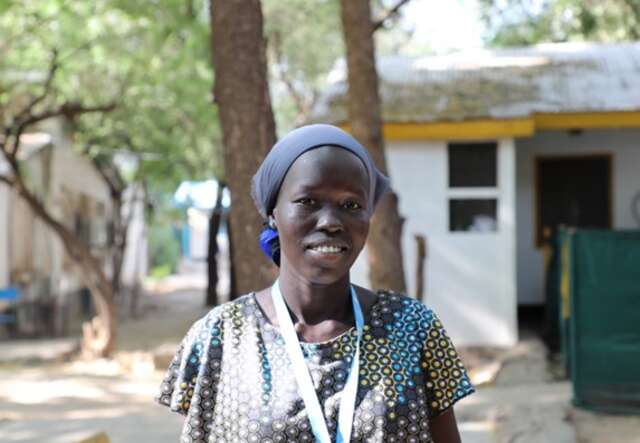 A photo showing a woman smiling to camera