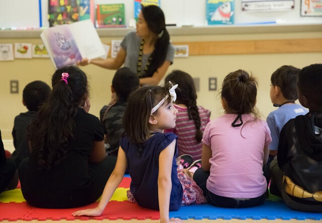 RYSA students sit attentively for an interactive reading activity.