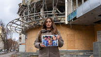 Marhartya holds a photo of her family together.