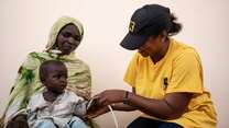 An IRC staff member screens a child in Chad for signs of malnutrition.