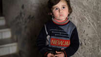 Syrian boy outside his home in Douma