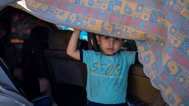 A 5-year-old boy looks out from the car his family is sheltering in on the Corniche after being displaced by Israeli airstrikes, on September 29, 2024 in Beirut, Lebanon.