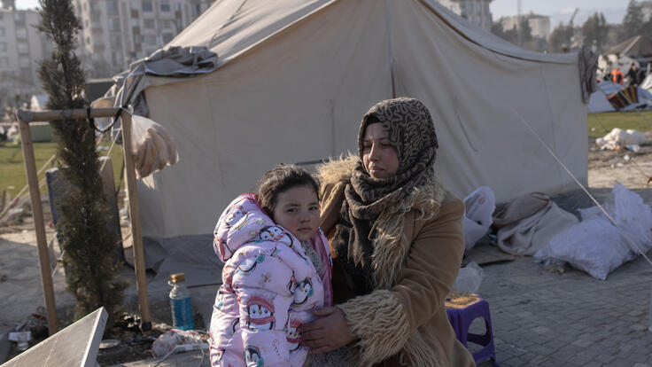 Latifa holds her daughter in her arms.