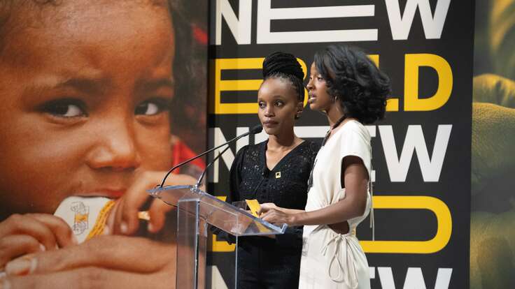 Two women standing at a podium