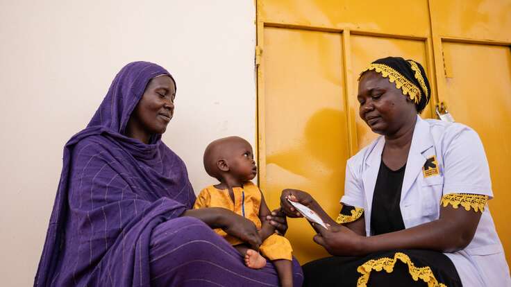 An IRC health care worker treats a young child for malnutrition in Chad.